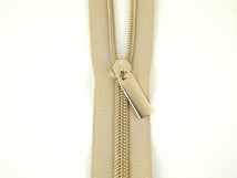 Zippers By The Yard Beige Tape 3 yds #5 nylon coil & 9 pulls - Gold